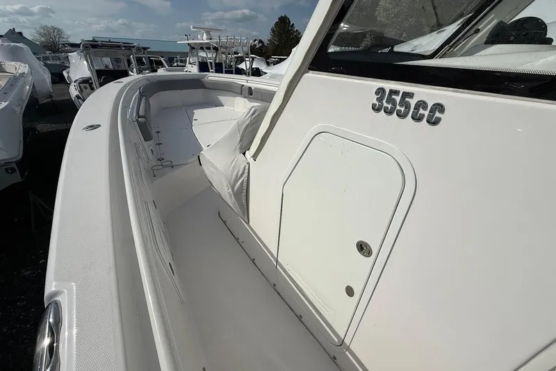 Slide: The Image of 2017 Everglades 355 Center Console boat, white exterior, docked with other boats. - 11
