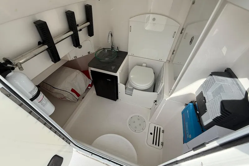 Slide: The Image of Interior of 2017 Everglades 355 Center Console boat with toilet and storage. - 12