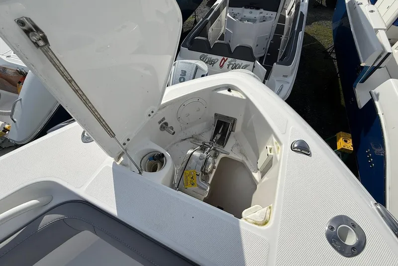 Slide: The Image of Open anchor compartment on 2017 Everglades 355 Center Console boat, showcasing storage and equipment. - 17