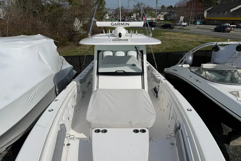 Slide: The Image of 2017 Everglades 355 Center Console boat with Garmin equipment, docked outdoors. - 18
