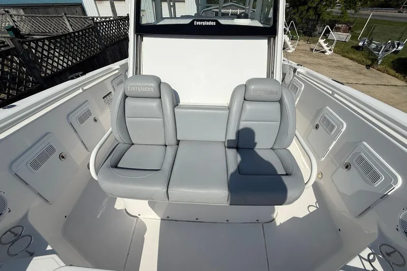 Slide: The Image of 2017 Everglades 355 Center Console boat with gray seating and storage compartments. - 21