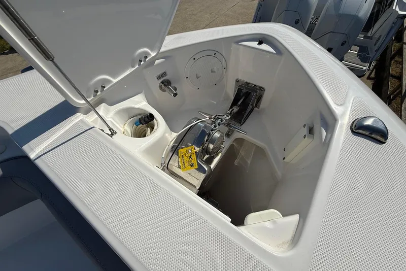 Slide: The Image of Open anchor compartment of 2017 Everglades 355 Center Console boat, showcasing storage and equipment. - 23