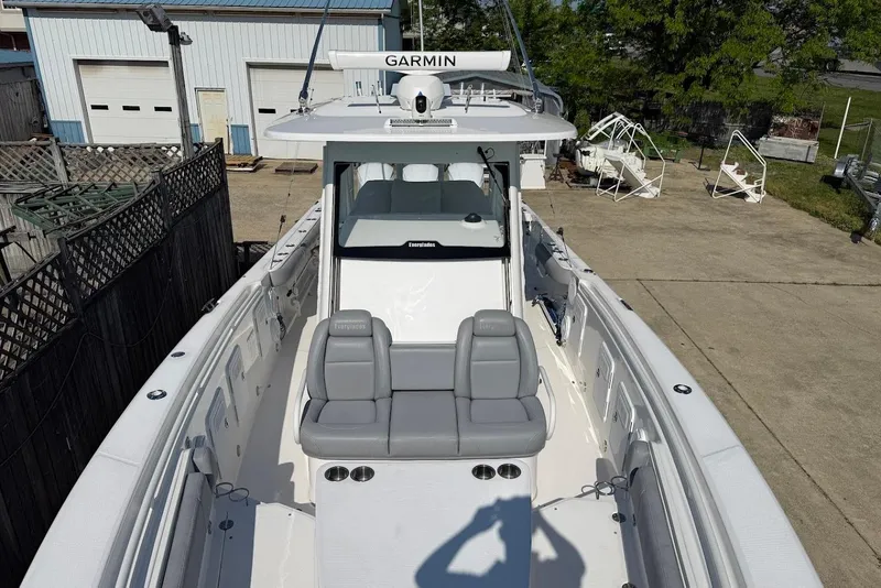Slide: The Image of 2017 Everglades 355 Center Console boat with Garmin equipment, docked outdoors. - 24