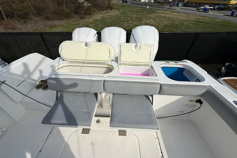 Slide: The Image of 2017 Everglades 355 Center Console boat with open storage compartments and seating. - 3