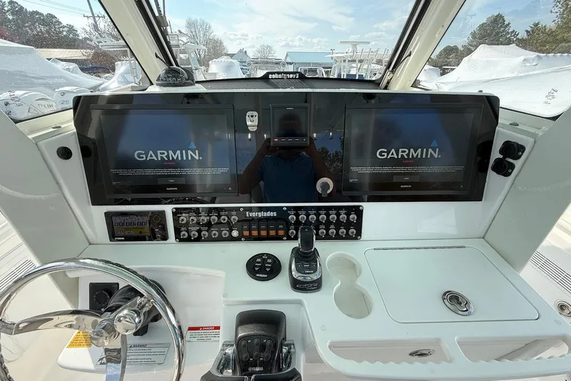 Slide: The Image of 2017 Everglades 355 Center Console helm with dual Garmin displays and control panel. - 8