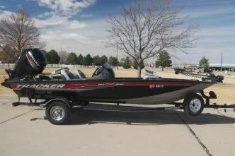 The Image of 2018 Tracker Pro Team 175 TXW fishing boat on trailer, parked outdoors. - 1