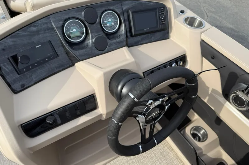 Slide: The Image of 2026 Avalon LSZ Quad Lounge boat dashboard with steering wheel and control panel. - 12