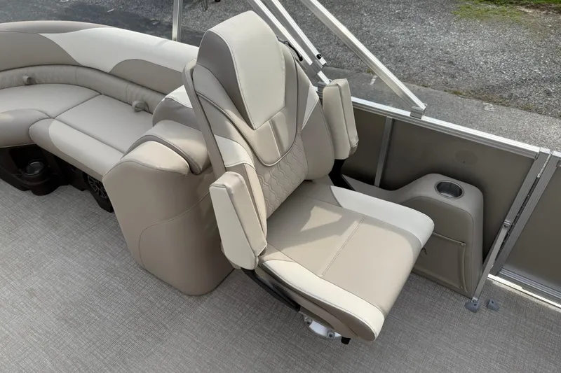 Slide: The Image of Luxurious seating on 2026 Avalon LSZ Quad Lounge boat, featuring beige upholstery and cup holder. - 14