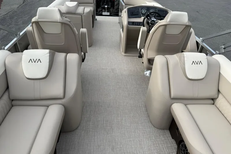 Slide: The Image of 2026 Avalon LSZ Quad Lounge boat interior with luxurious beige seating and modern dashboard. - 18