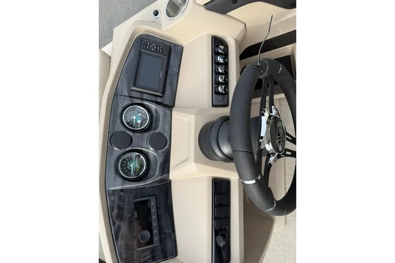 Slide: The Image of Steering console of 2026 Avalon LSZ Quad Lounge boat with gauges and controls. - 19