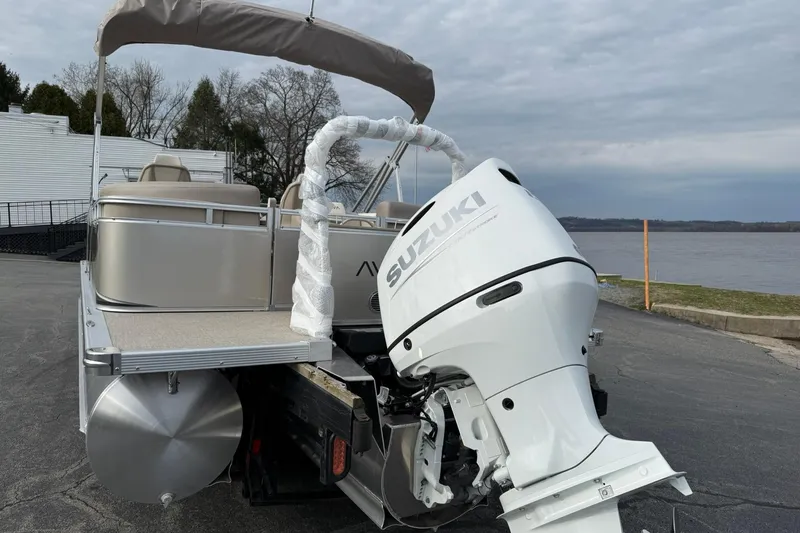 Slide: The Image of 2026 Avalon LSZ Quad Lounge boat with Suzuki outboard motor by a lake. - 3