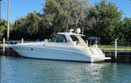 The Image of 2001 Sea Ray Sundancer 460 yacht docked by the water. - 0
