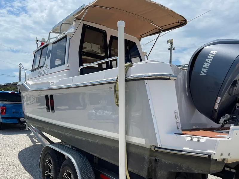 Slide: The Image of 2024 Ranger Tugs R-25 boat on trailer with Yamaha outboard motor. - 7