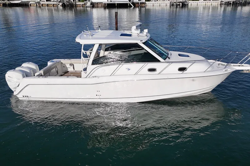 Slide: The Image of 2016 Boston Whaler 345 Conquest boat on calm water, side view. - 10