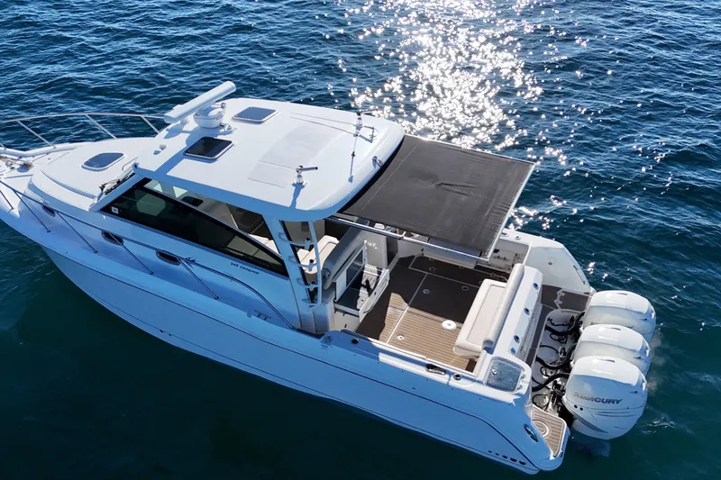 Slide: The Image of 2016 Boston Whaler 345 Conquest boat on sparkling blue water, aerial view. - 13