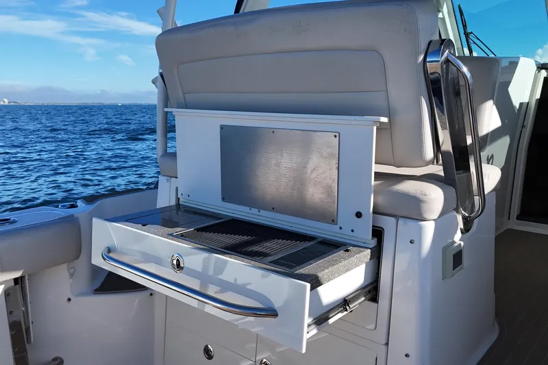 Slide: The Image of 2016 Boston Whaler 345 Conquest boat interior with built-in grill, ocean view. - 15