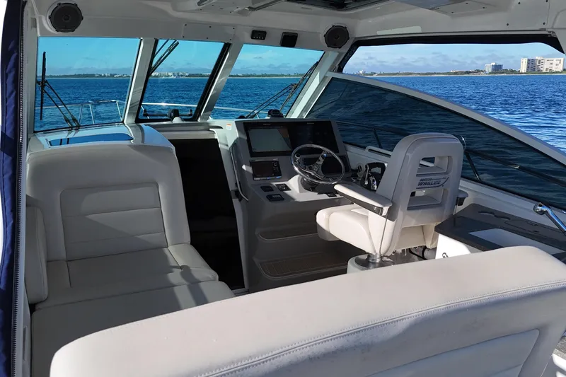 Slide: The Image of Interior view of 2016 Boston Whaler 345 Conquest boat, featuring helm and seating area. - 18