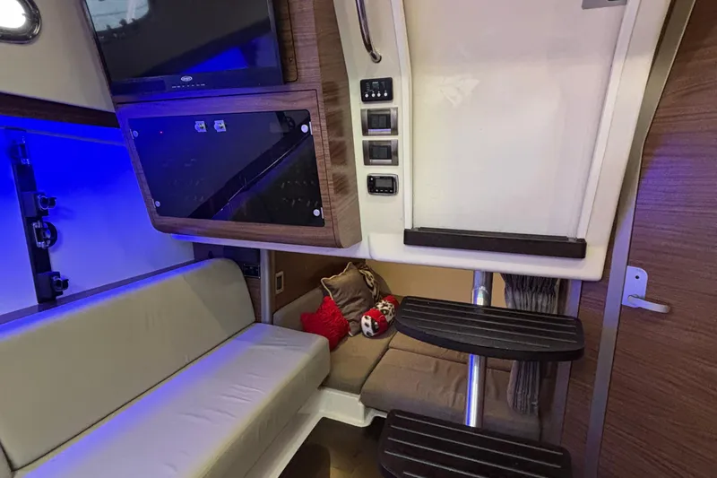 Slide: The Image of Interior of 2016 Boston Whaler 345 Conquest, featuring seating, steps, and ambient lighting. - 24