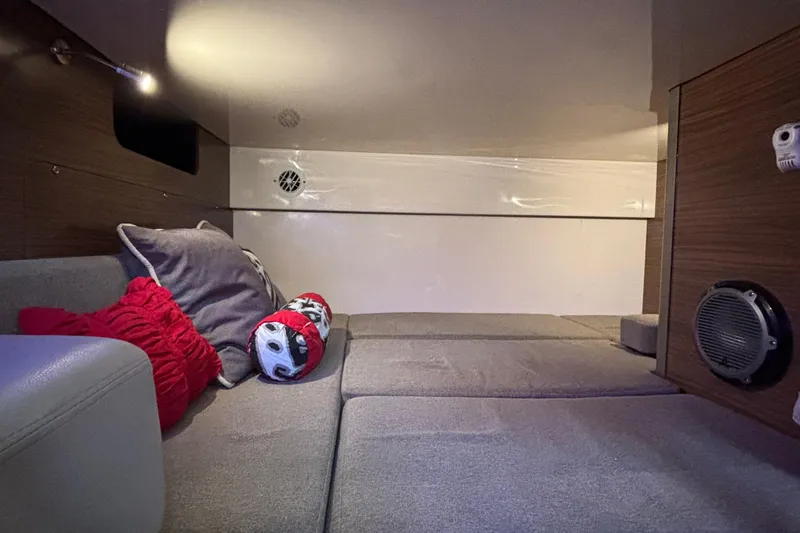 Slide: The Image of Interior cabin of 2016 Boston Whaler 345 Conquest with cozy seating and decorative pillows. - 26