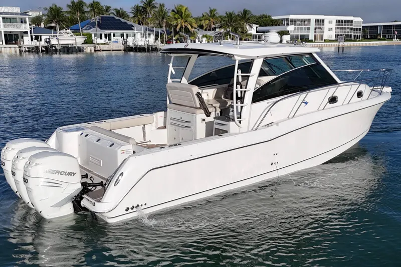 Slide: The Image of 2016 Boston Whaler 345 Conquest boat on calm water, featuring twin Mercury engines. - 8