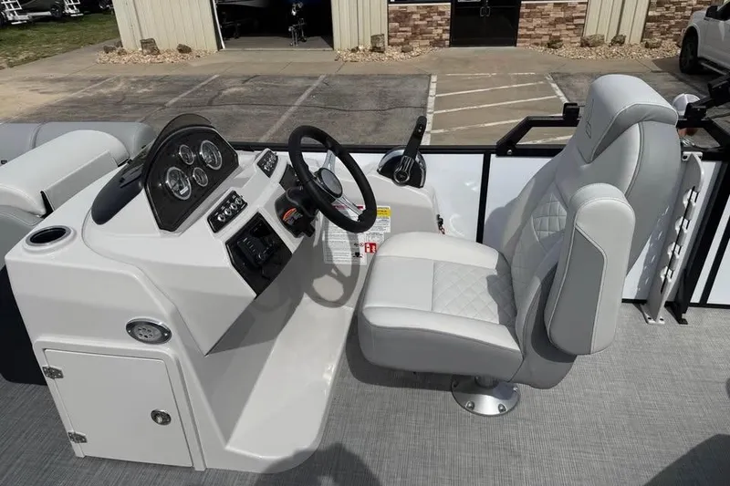 Slide: The Image of 2026 Lowe SF 232 Sport Fish boat cockpit with steering wheel and comfortable seating. - 12