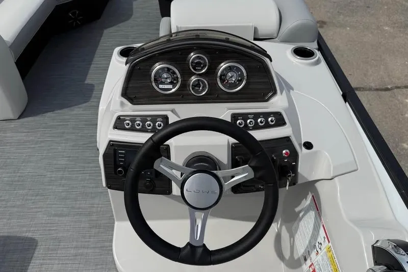 Slide: The Image of 2026 Lowe SF 232 Sport Fish boat dashboard with steering wheel and instrument panel. - 13