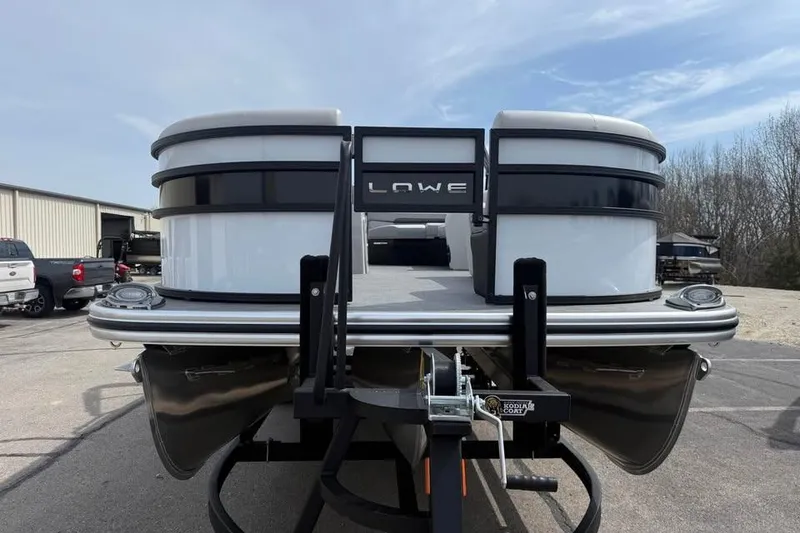 Slide: The Image of 2026 Lowe SF 232 Sport Fish pontoon boat on trailer, outdoor setting. - 2
