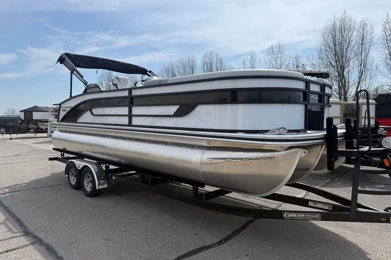 Slide: The Image of 2026 Lowe SF 232 Sport Fish pontoon boat on trailer, parked outdoors. - 3