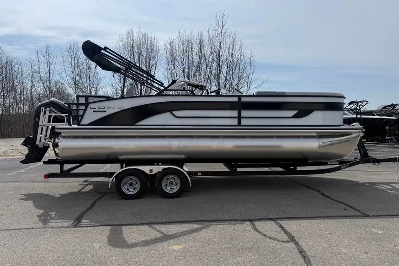 Slide: The Image of 2026 Lowe SF 232 Sport Fish pontoon boat on trailer, parked outdoors. - 4