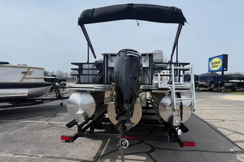 Slide: The Image of 2026 Lowe SF 232 Sport Fish pontoon boat with outboard motor, parked at BlackBeard Marine. - 5