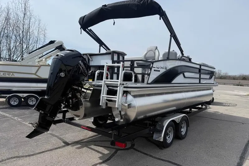 Slide: The Image of 2026 Lowe SF 232 Sport Fish pontoon boat on trailer, featuring a Mercury outboard motor. - 7