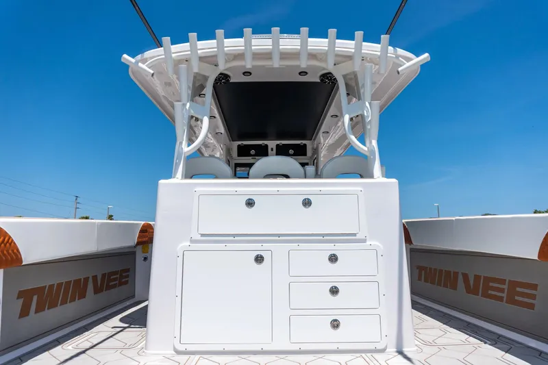 Slide: The Image of 2026 Twin Vee 400 GFX2 CC boat with storage and blue sky. - 12