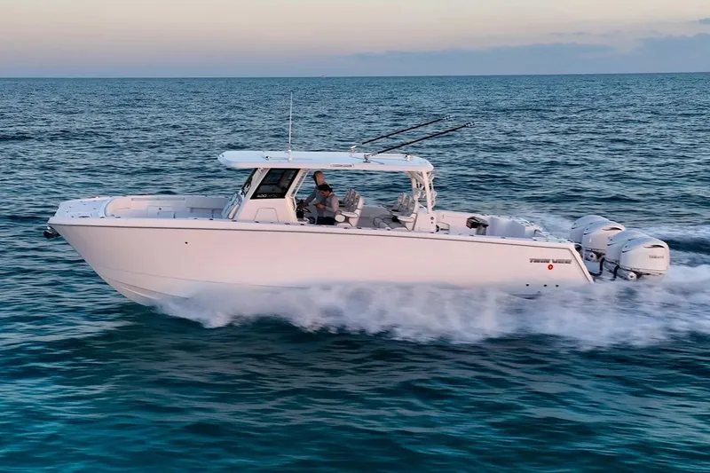 Slide: The Image of Manufacturer Provided Image: 2026 Twin Vee 400 GFX2 CC boat cruising on open water at sunset. - 23