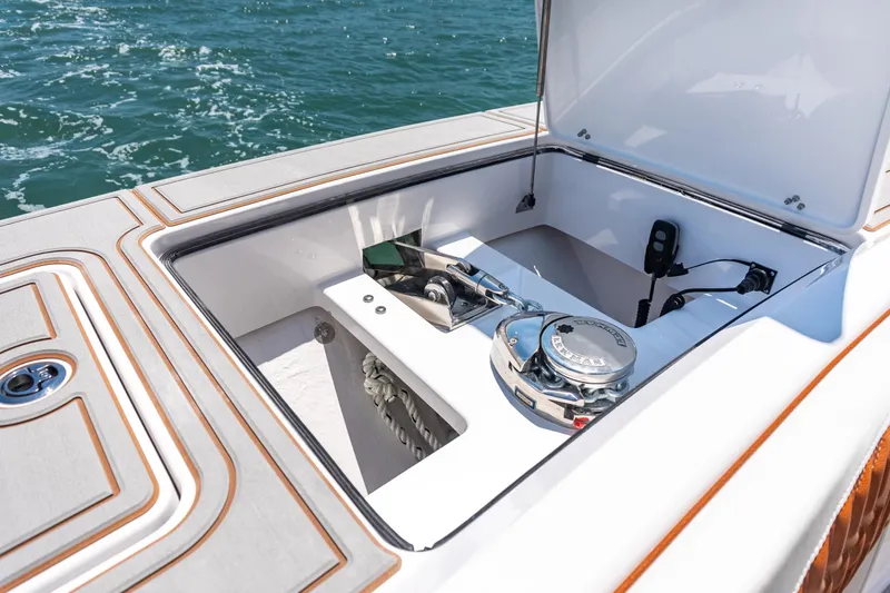 Slide: The Image of 2026 Twin Vee 400 GFX2 CC boat with open storage compartment lid. - 5