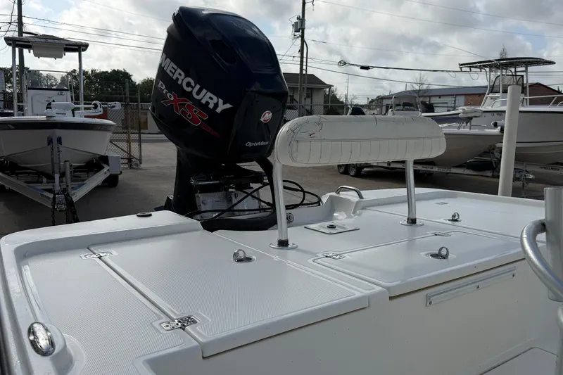 Slide: The Image of 2014 Mako 21 LTS boat with Mercury Pro XS outboard motor in a marina setting. - 11