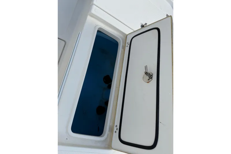 Slide: The Image of Open storage compartment on a 2014 Mako 21 LTS boat. - 14