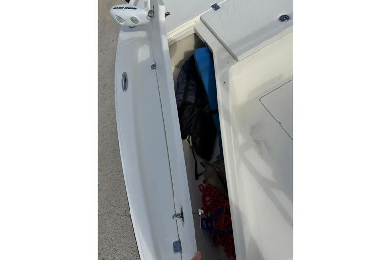 Slide: The Image of 2014 Mako 21 LTS boat storage compartment with gear and accessories. - 15