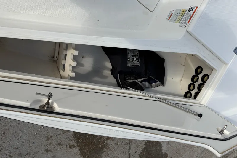 Slide: The Image of Open storage compartment in a 2014 Mako 21 LTS boat, showing interior details. - 17