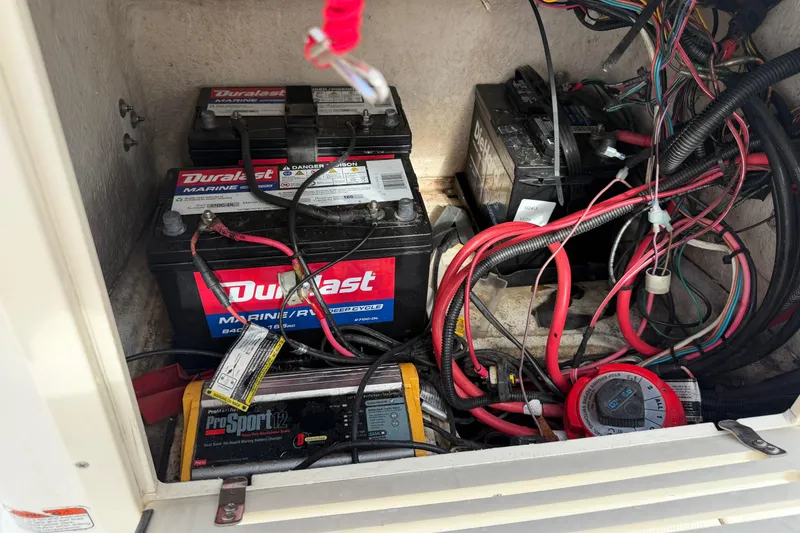 Slide: The Image of Battery compartment of a 2014 Mako 21 LTS boat with Duralast marine batteries. - 19