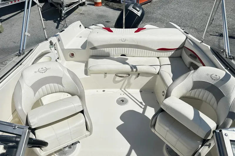 Slide: The Image of 2012 Stingray 234 LR boat interior with white seating and steering wheel. - 5