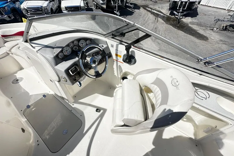 Slide: The Image of 2012 Stingray 234 LR boat cockpit with steering wheel and gauges. - 6