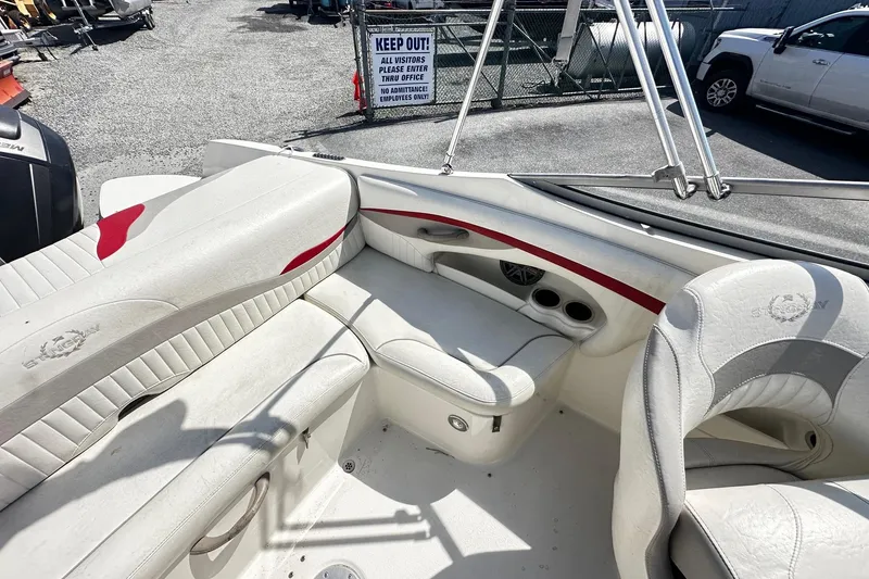 Slide: The Image of 2012 Stingray 234 LR boat interior with white seating and red accents. - 9