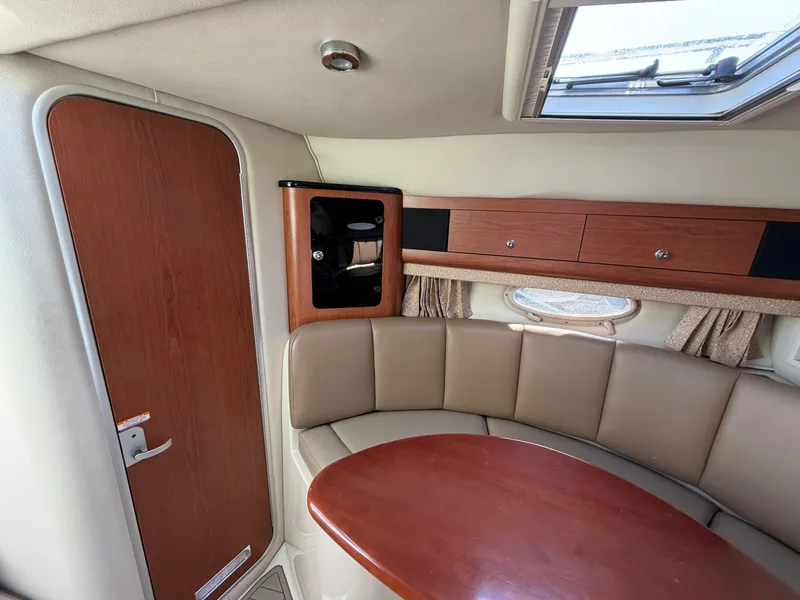 Slide: The Image of Interior of 2003 Chaparral 330 Signature with seating area and wood accents. - 11