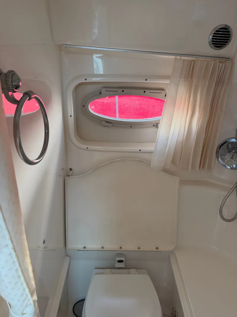 Slide: The Image of Interior of 2003 Chaparral 330 Signature yacht with window and toilet. - 16