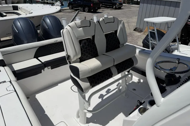 The Image of 2022 Tidewater 256 LXF boat interior with dual seats and steering console. - 11