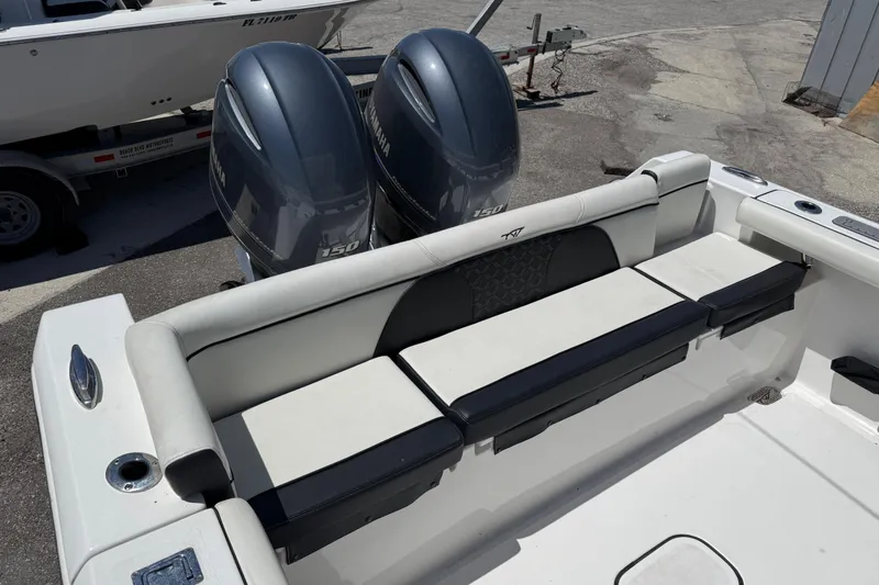 Slide: The Image of 2022 Tidewater 256 LXF boat with dual Yamaha 150 engines, featuring comfortable seating. - 12