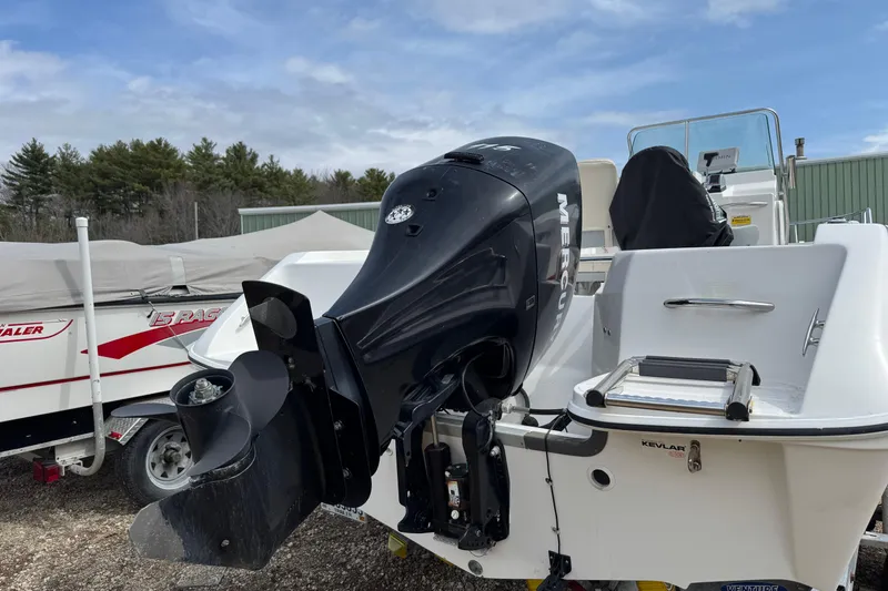 Slide: The Image of 2005 Campion Explorer 582 Center Console with Mercury outboard motor, parked outdoors. - 10