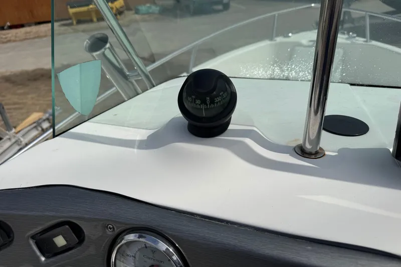 Slide: The Image of 2005 Campion Explorer 582 Center Console dashboard with compass and windshield. - 11