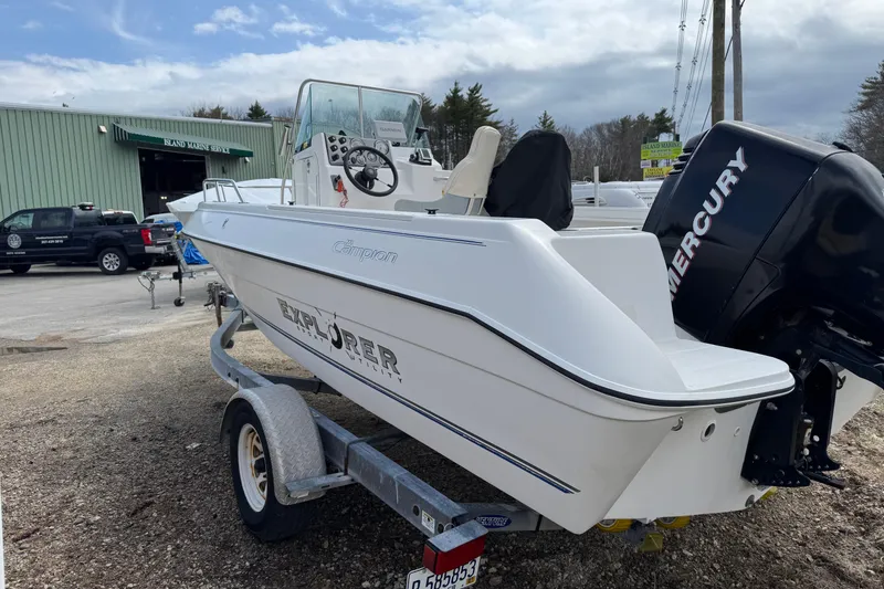 Slide: The Image of 2005 Campion Explorer 582 Center Console boat on trailer, parked near marine service. - 2