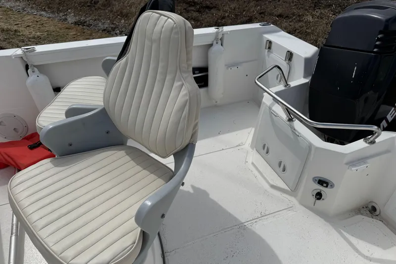 Slide: The Image of 2005 Campion Explorer 582 Center Console boat interior with seating and engine. - 4